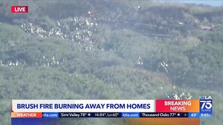 Evacuations remain as brush fire burns near Laguna Beach