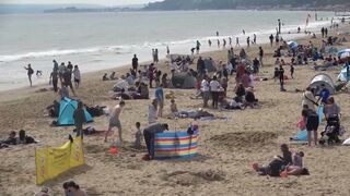 Bournemouth Beach crowded with Easter Sunday visitors during warm weather on the South Coast of UK.