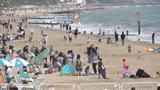 Bournemouth Beach crowded with Easter Sunday visitors during warm weather on the South Coast of UK.