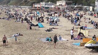 Bournemouth Beach crowded with Easter Sunday visitors during warm weather on the South Coast of UK.