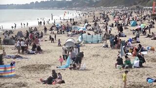 Bournemouth Beach crowded with Easter Sunday visitors during warm weather on the South Coast of UK.