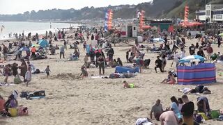 Bournemouth Beach crowded with Easter Sunday visitors during warm weather on the South Coast of UK.