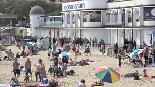 Bournemouth Beach crowded with Easter Sunday visitors during warm weather on the South Coast of UK.