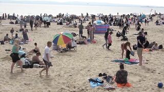 Bournemouth Beach crowded with Easter Sunday visitors during warm weather on the South Coast of UK.