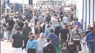 Bournemouth Beach crowded with Easter Sunday visitors during warm weather on the South Coast of UK.