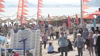 Bournemouth Beach crowded with Easter Sunday visitors during warm weather on the South Coast of UK.