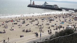 Bournemouth Beach crowded with Easter Sunday visitors during warm weather on the South Coast of UK.