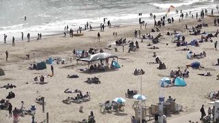 Bournemouth Beach crowded with Easter Sunday visitors during warm weather on the South Coast of UK.