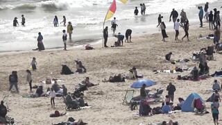 Bournemouth Beach crowded with Easter Sunday visitors during warm weather on the South Coast of UK.