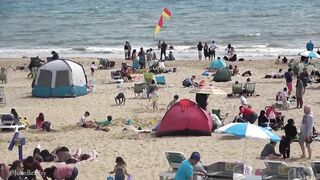 Bournemouth Beach crowded with Easter Sunday visitors during warm weather on the South Coast of UK.