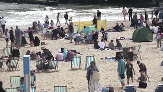 Bournemouth Beach crowded with Easter Sunday visitors during warm weather on the South Coast of UK.