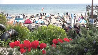 Bournemouth Beach crowded with Easter Sunday visitors during warm weather on the South Coast of UK.