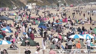 Bournemouth Beach crowded with Easter Sunday visitors during warm weather on the South Coast of UK.