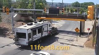 Camper trailer loses equipment at the 11foot8+8 bridge