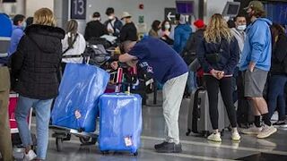 VERY EARLY ARRIVALS: Passengers try to beat airport security bottlenecks as travel ramps up