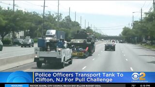 Police officers transport tank to Clifton, N.J., for pull challenge