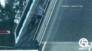 Video shows bicyclist cling to North Palm Beach bridge as it rises