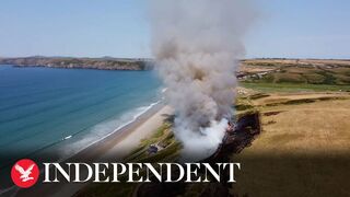 UK heatwave: Drone footage shows huge gorse fire at Welsh beach as temperatures soar