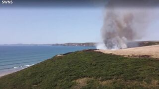 UK heatwave: Drone footage shows huge gorse fire at Welsh beach as temperatures soar