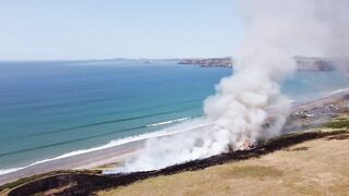 UK heatwave: Drone footage shows huge gorse fire at Welsh beach as temperatures soar