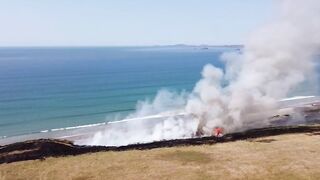 UK heatwave: Drone footage shows huge gorse fire at Welsh beach as temperatures soar