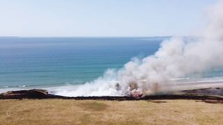 UK heatwave: Drone footage shows huge gorse fire at Welsh beach as temperatures soar