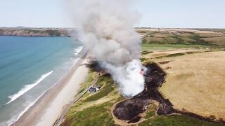 UK heatwave: Drone footage shows huge gorse fire at Welsh beach as temperatures soar