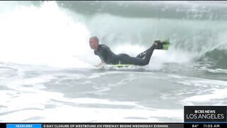 Onlookers gather at The Wedge in Newport Beach as high-powered swells hit SoCal