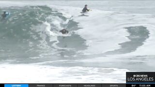 Onlookers gather at The Wedge in Newport Beach as high-powered swells hit SoCal