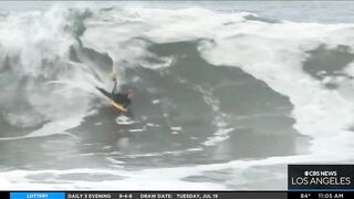 Onlookers gather at The Wedge in Newport Beach as high-powered swells hit SoCal