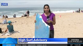 Onlookers gather at The Wedge in Newport Beach as high-powered swells hit SoCal