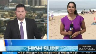 Onlookers gather at The Wedge in Newport Beach as high-powered swells hit SoCal