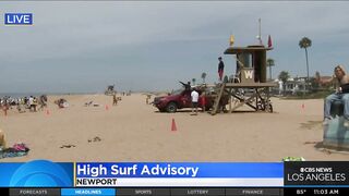 Onlookers gather at The Wedge in Newport Beach as high-powered swells hit SoCal