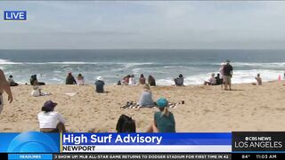 Onlookers gather at The Wedge in Newport Beach as high-powered swells hit SoCal