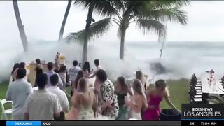 Onlookers gather at The Wedge in Newport Beach as high-powered swells hit SoCal