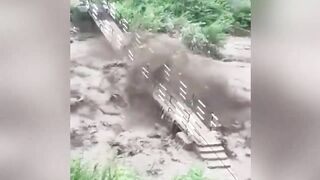 Buildings and cars are swept away with a huge stream of flood in Himachal Pradesh, India