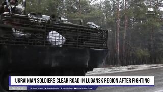 Ukrainian soldiers clear road in Lugansk region after fighting