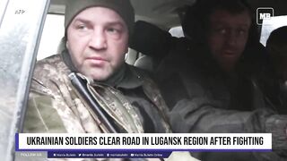 Ukrainian soldiers clear road in Lugansk region after fighting