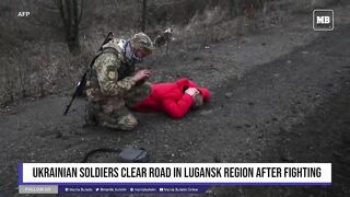 Ukrainian soldiers clear road in Lugansk region after fighting