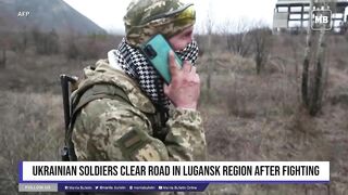 Ukrainian soldiers clear road in Lugansk region after fighting