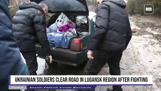 Ukrainian soldiers clear road in Lugansk region after fighting