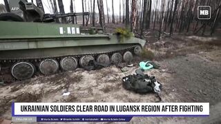 Ukrainian soldiers clear road in Lugansk region after fighting