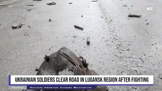 Ukrainian soldiers clear road in Lugansk region after fighting