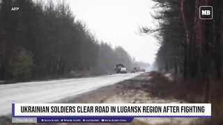 Ukrainian soldiers clear road in Lugansk region after fighting