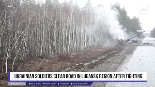 Ukrainian soldiers clear road in Lugansk region after fighting