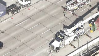 Big rig overturns on car on 405 Freeway in Seal Beach