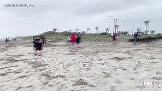 Hurricane Nicole: Weather tourists on Indialantic Beach in Melbourne, Florida