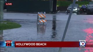 Police officers warn of pooling on the roads in Hollywood Beach