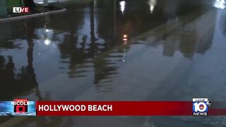 Police officers warn of pooling on the roads in Hollywood Beach