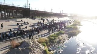 DRONE shows long queue of migrants stretching miles along US border wall